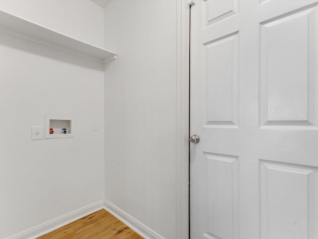 washroom featuring baseboards, light wood-style floors, laundry area, and washer hookup