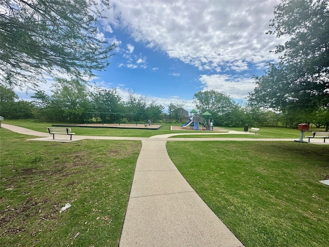 view of community with playground community and a yard