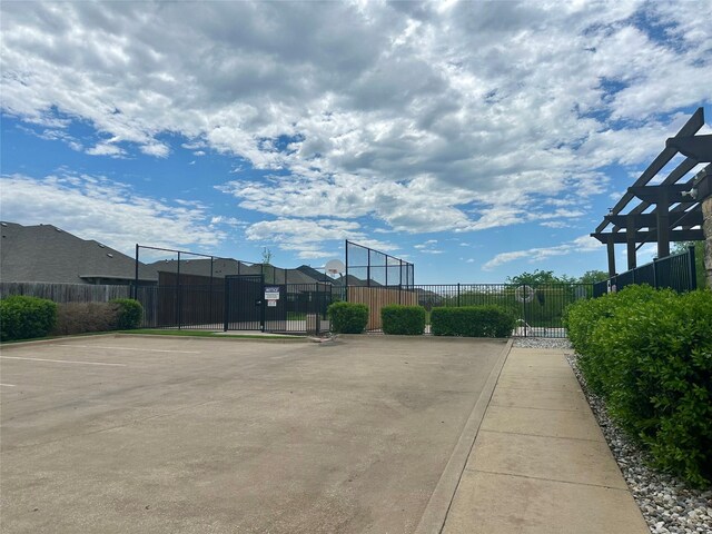 view of basketball court featuring fence