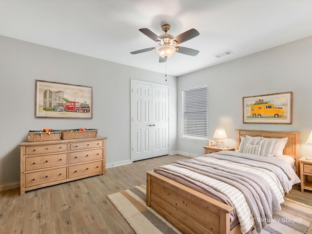 bedroom with visible vents, a closet, baseboards, light wood-style flooring, and ceiling fan
