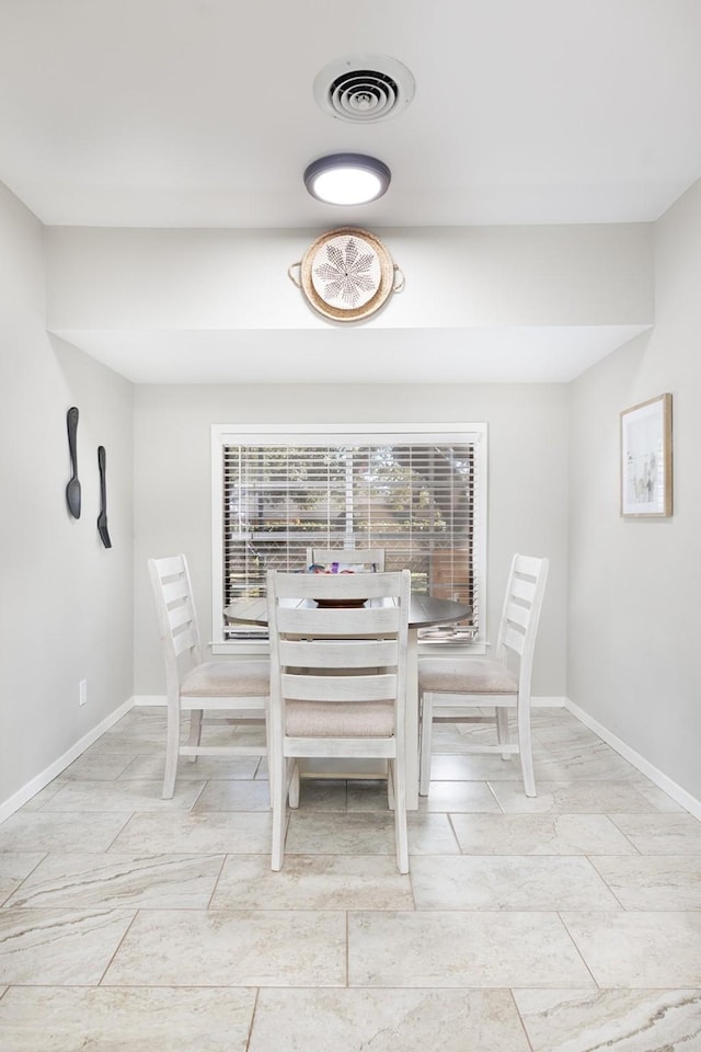 dining space featuring baseboards and visible vents