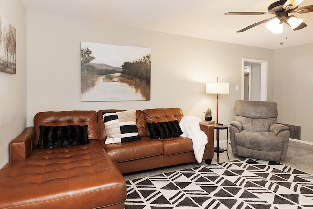 living room featuring baseboards, visible vents, and ceiling fan