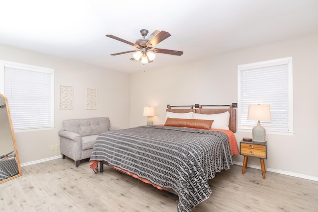 bedroom featuring baseboards, a ceiling fan, and wood finished floors