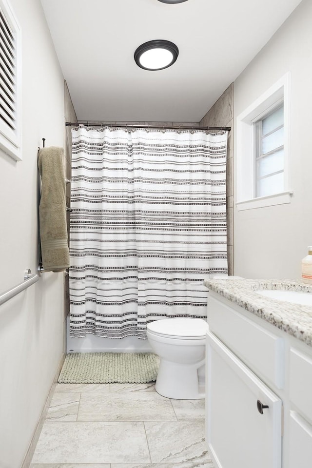 bathroom featuring shower / bath combo with shower curtain, toilet, and vanity
