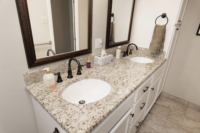 bathroom with a sink and double vanity
