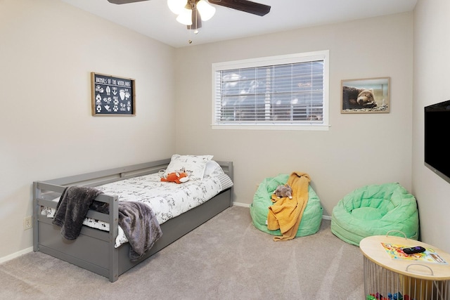 carpeted bedroom with a ceiling fan and baseboards