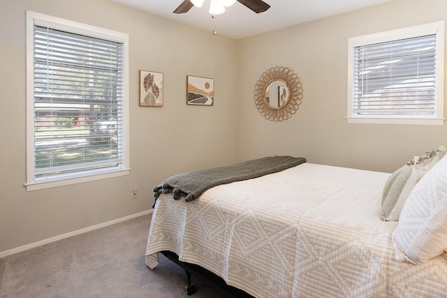 bedroom with baseboards, carpet flooring, and multiple windows