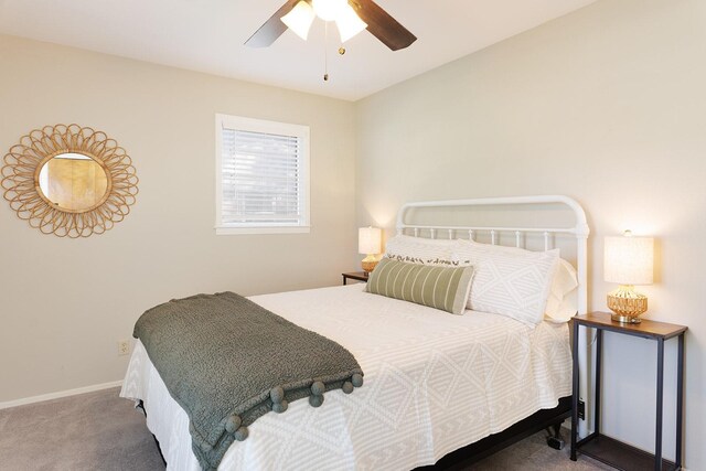 carpeted bedroom with ceiling fan and baseboards
