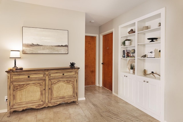 corridor featuring baseboards