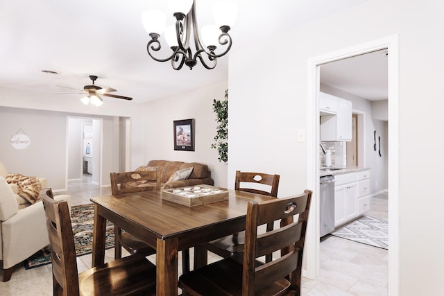 dining area featuring ceiling fan with notable chandelier, baseboards, visible vents, and light tile patterned flooring