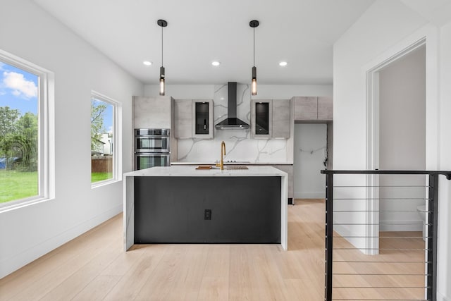 1926 Pueblo St, Dallas, TX 75212 - kitchen with modern cabinets, wall chimney exhaust hood, light countertops, double oven, and light wood-style flooring