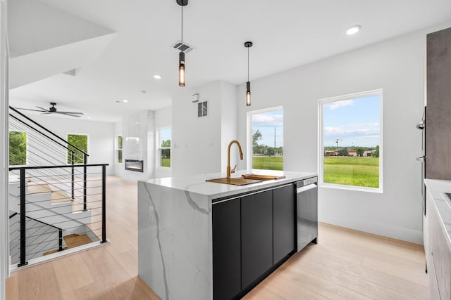 1926 Pueblo St, Dallas, TX 75212 - kitchen featuring hanging light fixtures, a sink, dark cabinetry, an island with sink, and stainless steel dishwasher