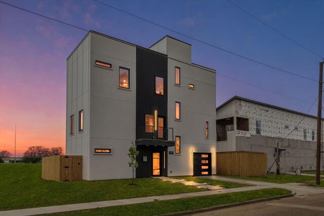1926 Pueblo St, Dallas, TX 75212 - view of front facade with a garage, concrete driveway, a front yard, and a balcony