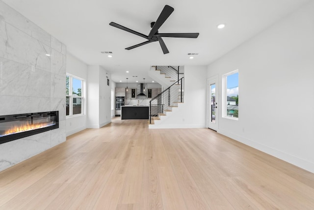 1926 Pueblo St, Dallas, TX 75212 - unfurnished living room featuring visible vents, a tile fireplace, stairway, recessed lighting, and light wood-style flooring