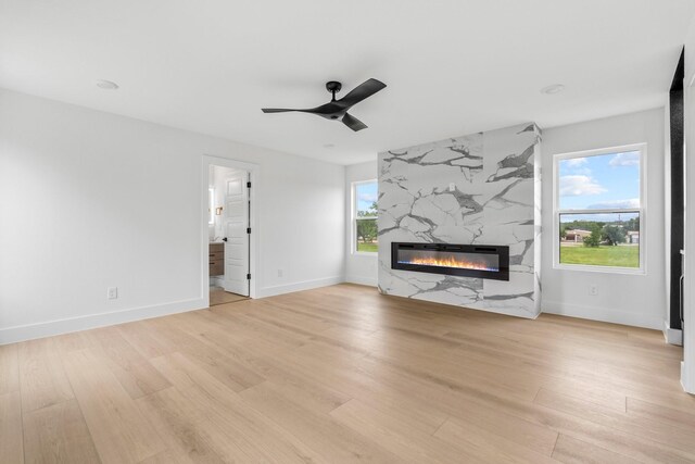 1926 Pueblo St, Dallas, TX 75212 - unfurnished living room featuring light wood-type flooring, a ceiling fan, baseboards, and a premium fireplace