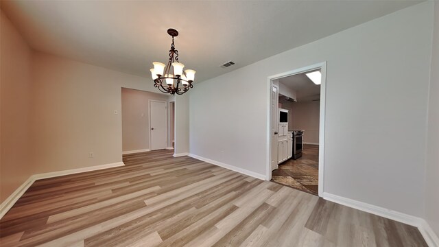 2300 Anders Dr, Mesquite, TX 75150 - unfurnished dining area featuring baseboards, a chandelier, visible vents, and light wood-style floors