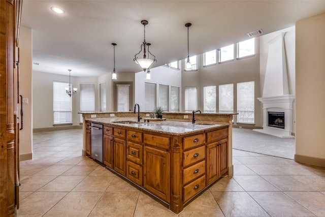 4312 Blue Quail Dr, Mckinney, TX 75072 - kitchen featuring brown cabinets, a sink, stainless steel dishwasher, a kitchen island with sink, and recessed lighting