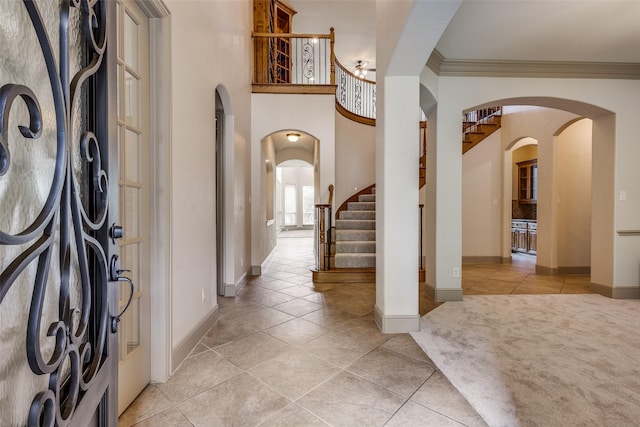 4312 Blue Quail Dr, Mckinney, TX 75072 - foyer with light tile patterned flooring, arched walkways, baseboards, ornamental molding, and stairway