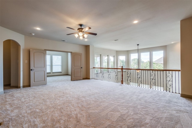 4312 Blue Quail Dr, Mckinney, TX 75072 - empty room featuring ceiling fan, baseboards, light carpet, arched walkways, and recessed lighting