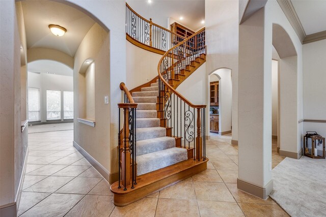 4312 Blue Quail Dr, Mckinney, TX 75072 - stairs featuring arched walkways, baseboards, ornamental molding, and tile patterned floors