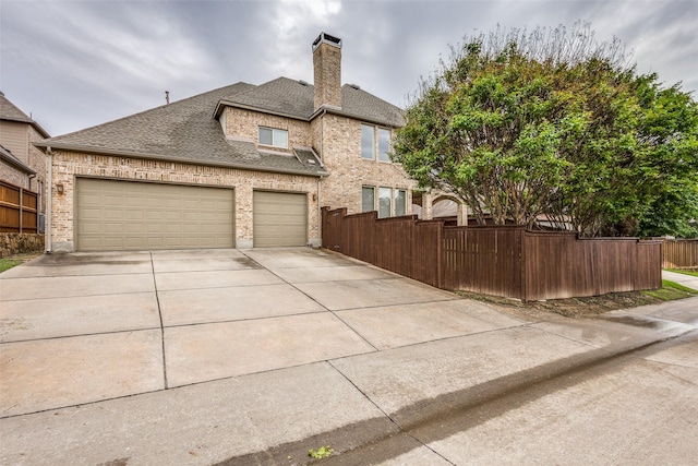 4312 Blue Quail Dr, Mckinney, TX 75072 - view of front of house featuring driveway, fence, a chimney, a shingled roof, and brick siding