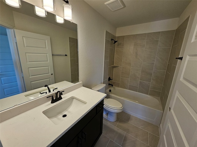 bathroom featuring tile patterned floors, bathing tub / shower combination, visible vents, toilet, and vanity