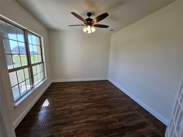 unfurnished room featuring ceiling fan, baseboards, and visible vents