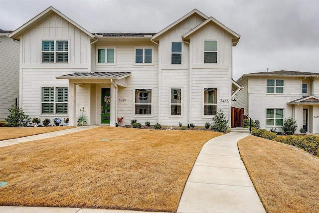 view of front of property with board and batten siding and a front yard