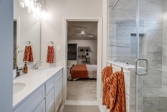 bathroom with double vanity, a ceiling fan, a marble finish shower, a sink, and ensuite bathroom