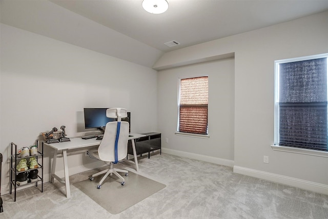 carpeted office space with baseboards, vaulted ceiling, and visible vents