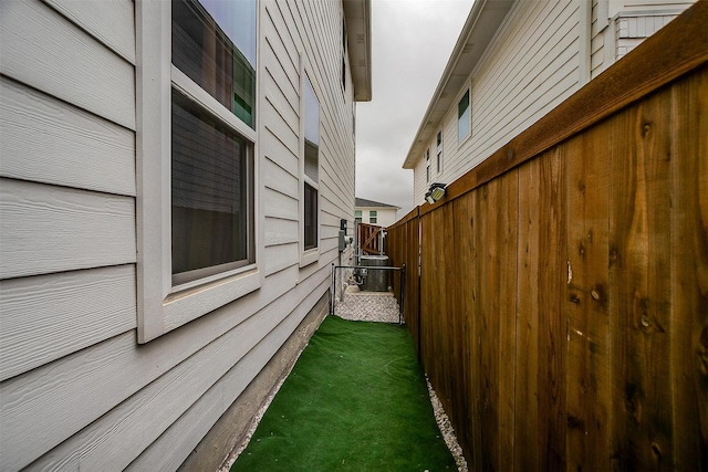 view of property exterior with fence and central air condition unit