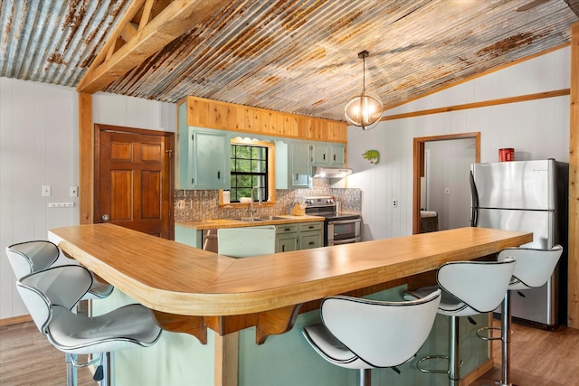230 W Sesame St, Karnack, TX 75661 - kitchen with stainless steel appliances, green cabinetry, wooden counters, light wood finished floors, and under cabinet range hood