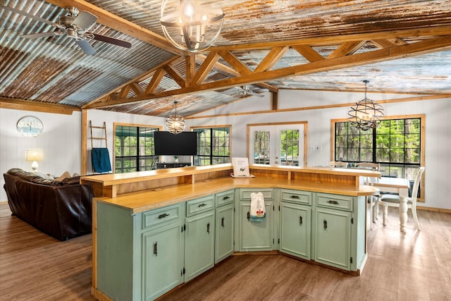 230 W Sesame St, Karnack, TX 75661 - kitchen featuring green cabinetry, wood finished floors, a ceiling fan, a chandelier, and vaulted ceiling