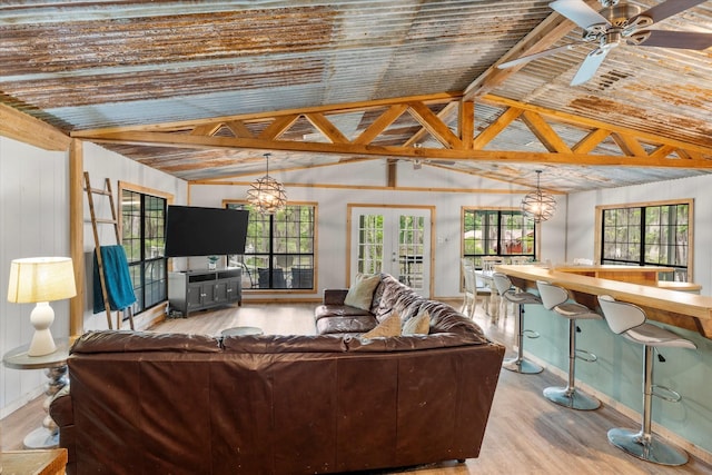 230 W Sesame St, Karnack, TX 75661 - living area featuring wood finished floors, lofted ceiling, a chandelier, baseboards, and ceiling fan