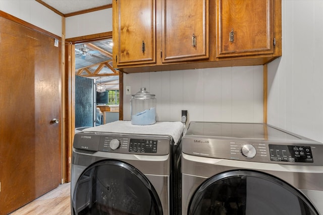 230 W Sesame St, Karnack, TX 75661 - laundry room with separate washer and dryer, cabinet space, light wood-style flooring, ornamental molding, and a ceiling fan