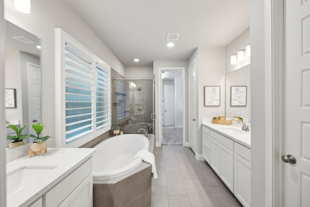 8517 Holliday Creek Way, Mckinney, TX 75071 - full bathroom featuring a shower stall, a garden tub, tile patterned flooring, two vanities, and recessed lighting