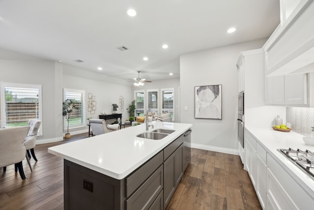 8517 Holliday Creek Way, Mckinney, TX 75071 - kitchen featuring a sink, light countertops, open floor plan, stainless steel appliances, and dark wood finished floors