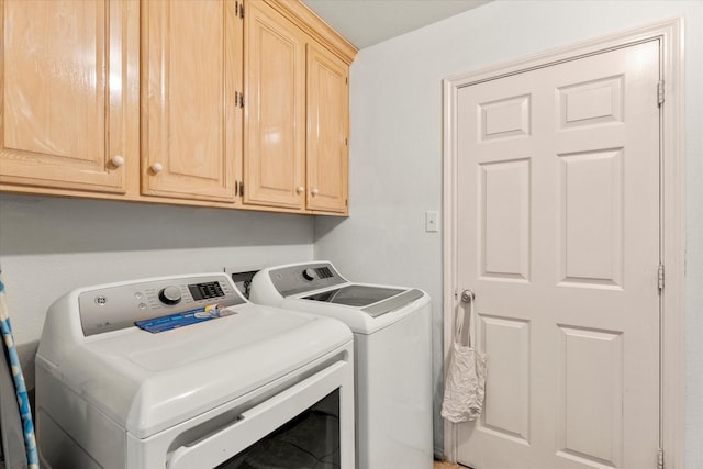 laundry area featuring washing machine and dryer and cabinet space