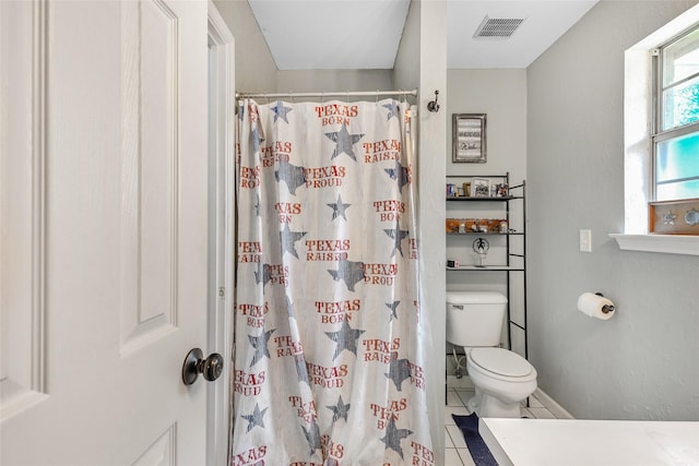 103 Elm St, Roxton, TX 75477 - full bathroom featuring a shower with shower curtain, visible vents, tile patterned flooring, and toilet