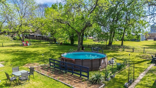 103 Elm St, Roxton, TX 75477 - view of swimming pool with fence and a lawn