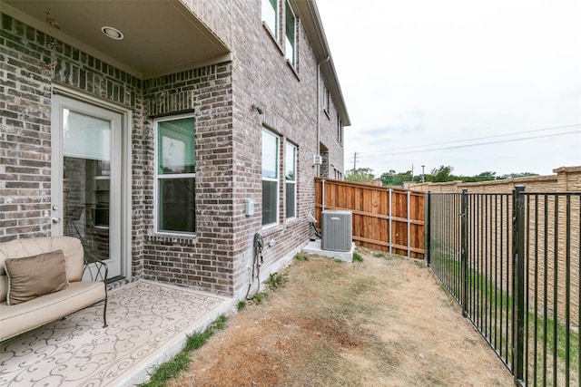 exterior space with a fenced backyard and central AC unit