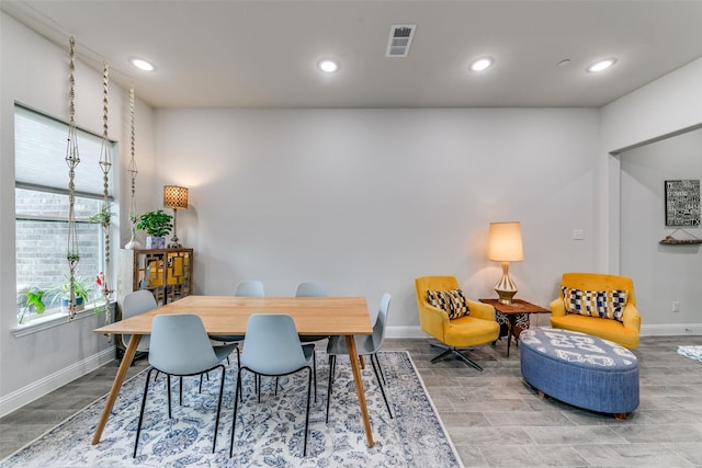 dining room featuring baseboards, wood finished floors, and visible vents