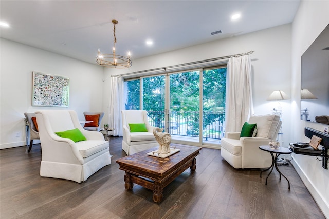 living room featuring recessed lighting, wood finished floors, and an inviting chandelier