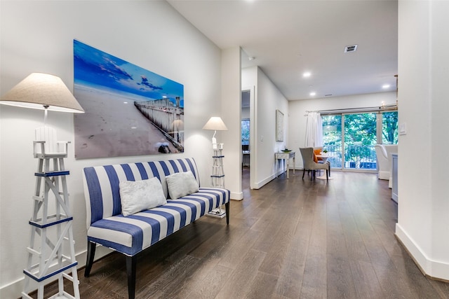 living room with baseboards, wood finished floors, visible vents, and recessed lighting