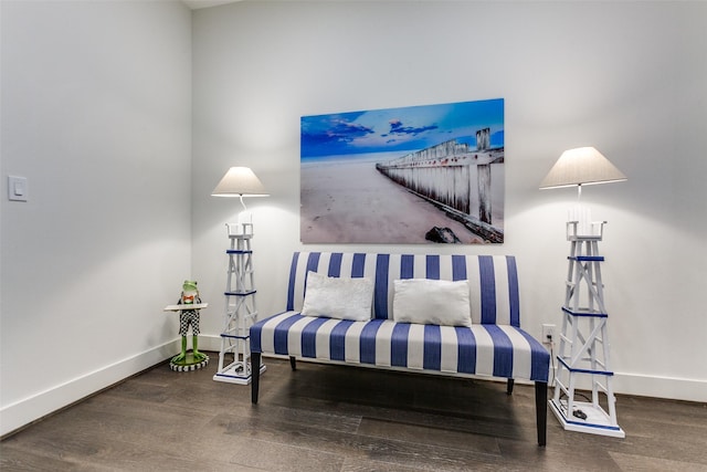 living area featuring baseboards and wood finished floors