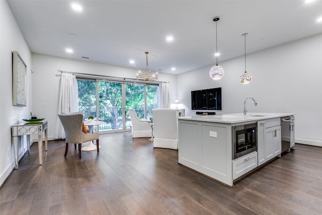 kitchen with dark wood finished floors, light countertops, dishwasher, black microwave, and baseboards