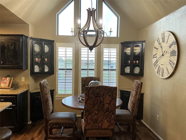 1302 Summit Dr, Mexia, TX 76667 - dining room with a textured ceiling, a notable chandelier, high vaulted ceiling, and dark wood finished floors