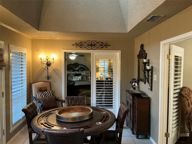 1302 Summit Dr, Mexia, TX 76667 - dining space featuring a raised ceiling, a textured ceiling, visible vents, and light tile patterned floors