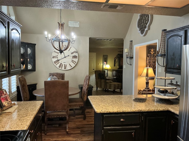 1302 Summit Dr, Mexia, TX 76667 - dining room featuring dark wood-type flooring, a chandelier, lofted ceiling, and visible vents