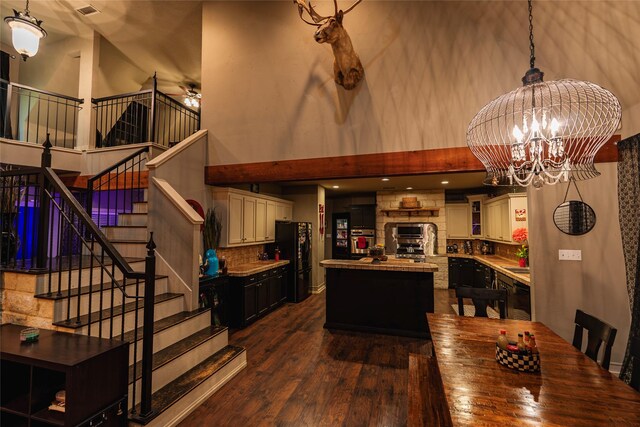 3408 Fm 2280, Cleburne, TX 76031 - dining room featuring a high ceiling, dark wood finished floors, a chandelier, stairs, and ceiling fan